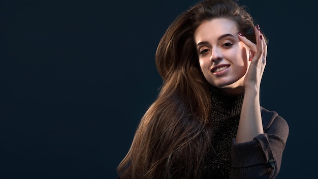 Closeup portrait of charming young thinking woman looking to the side on dark background