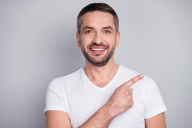 Closeup portrait of cheerful confident guy showing copy empty blank place