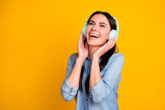 Closeup portrait of cheerful girl listening music look empty space