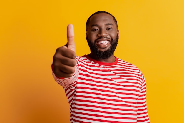 Closeup portrait of cheerful positive young man raise thumb up