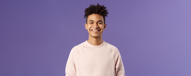 Photo closeup portrait of cheerful young hipster guy with dreads smiling optimistic and delighted standing