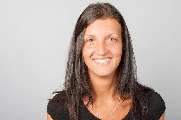 Closeup portrait of confident smiling happy pretty young woman in black shirt