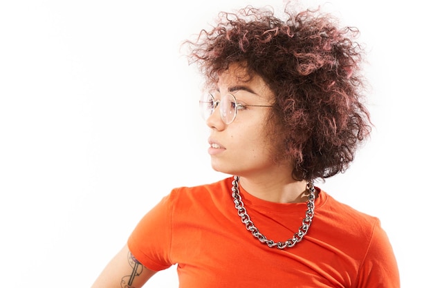 Photo closeup portrait of cool kazakh model girl with curls tattoo and chain with serious face isolated on white studio background