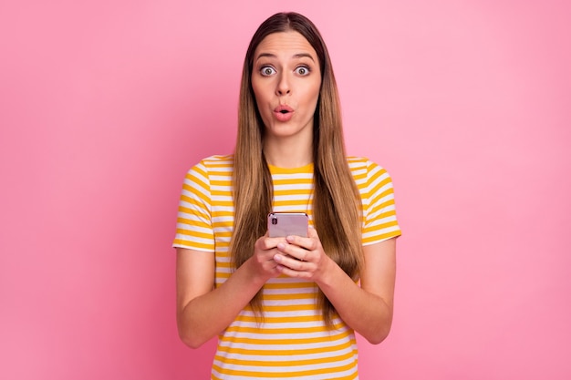 Closeup portrait of cute amazed girl using phone omg reaction