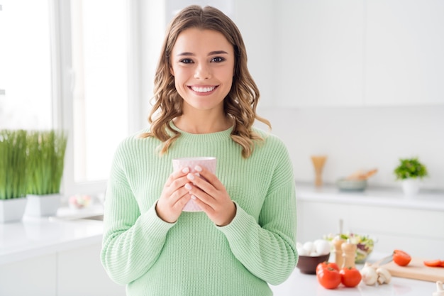 Closeup portrait of cute girl cooking fresh tasty meal drinking sweet cacao