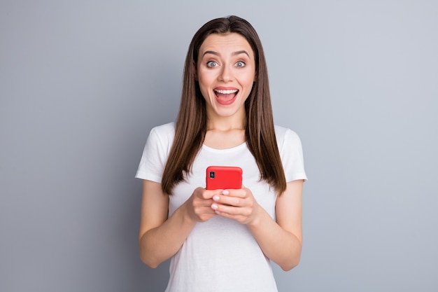 Closeup portrait of excited girl using digital phone good news omg