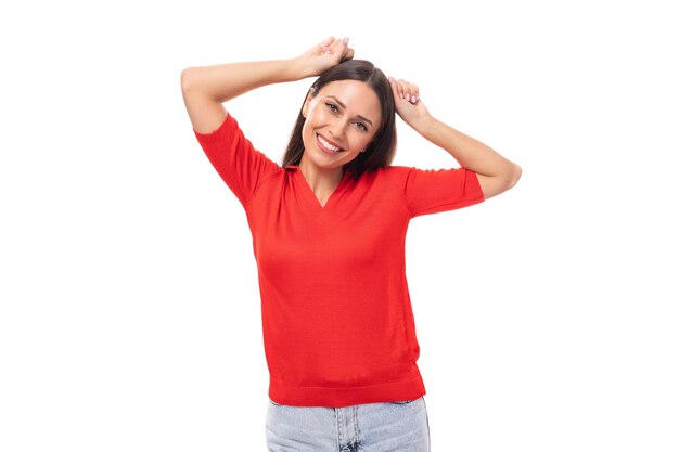 Closeup portrait of a funny young european brunette lady in a red tshirt with a grimace