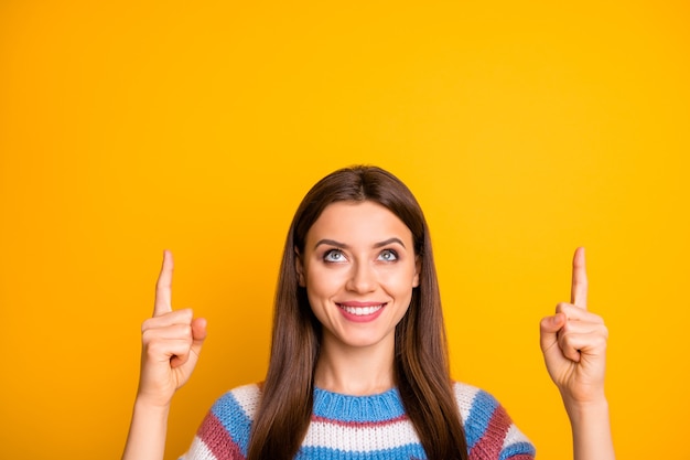 Closeup portrait of girl pointing two forefingers up copy space