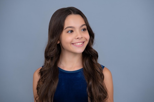 Closeup portrait of girl teen face Portrait of a cute teen child Studio shot isolated background Happy girl face positive and smiling emotions