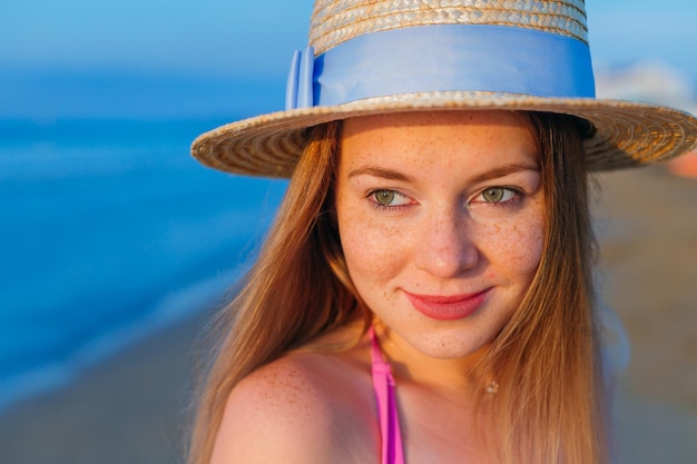 Closeup portrait of girl with freckles in stylish boater