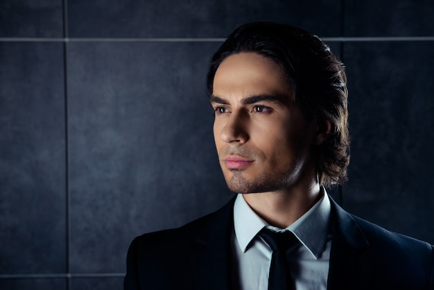 Closeup portrait of handsome hispanic young man in formalwear loking away