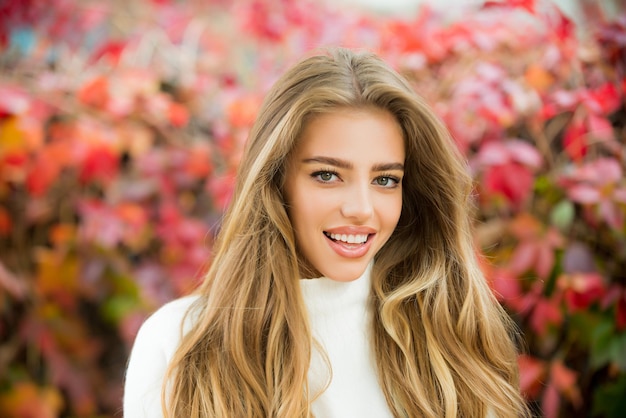 Closeup portrait of happy beautiful autumn woman outdoors