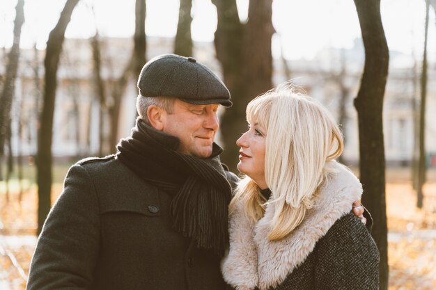 Closeup portrait of a happy blonde mature woman and a beautiful brunette middle-aged man