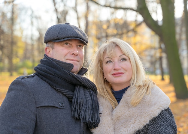 Closeup portrait of happy blonde mature woman and beautiful middle-aged brunette,