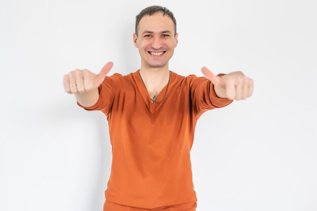 Closeup portrait of happy businessman shows thumbs up isolated on white background.