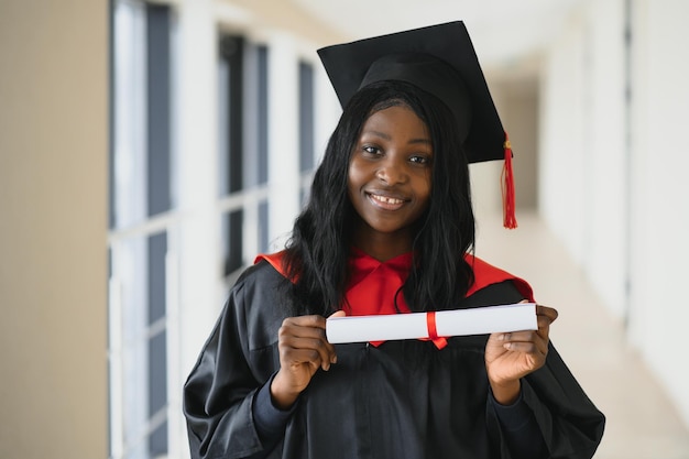 Closeup portrait of happy female student with certificate in college campus