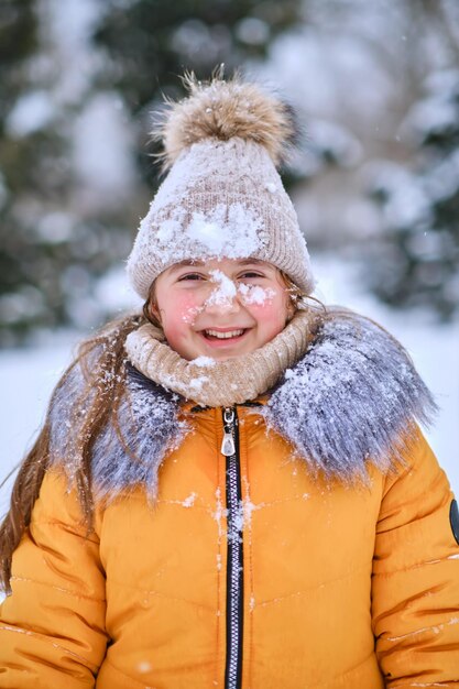 Closeup portrait of a happy girl in a furry hood