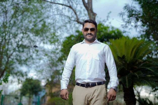 Closeup portrait happy handsome business man smiling in white shirt blazerconfident and friendly isolated outdoors outdoors background Corporate success