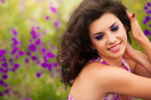 Closeup portrait of happy romantic woman with curly brown hair