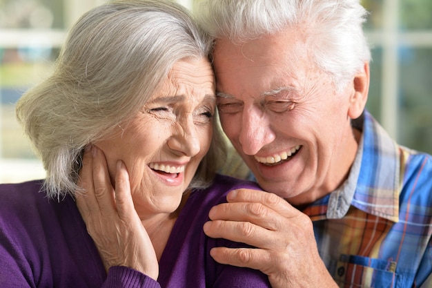 Closeup portrait of a happy senior couple at home