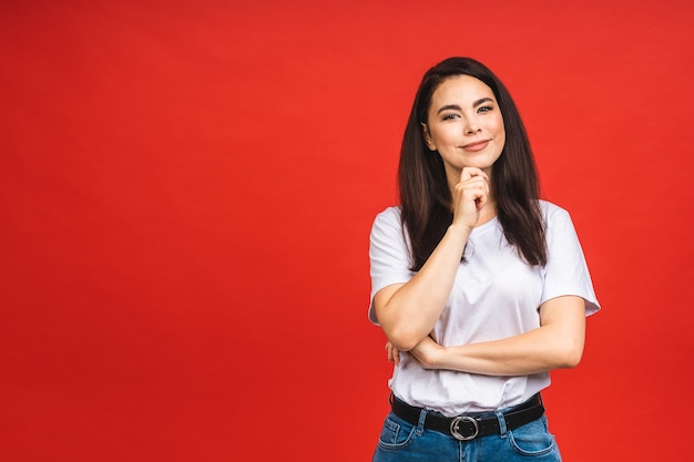 Closeup portrait of happy smiling brunette business girl woman in casual isolated over red background