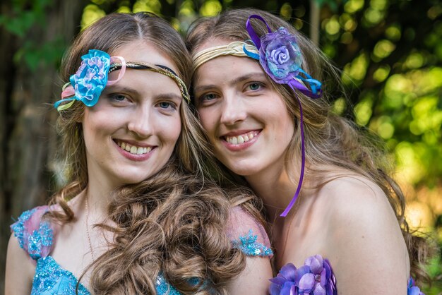 Closeup portrait happy smiling sisters twins