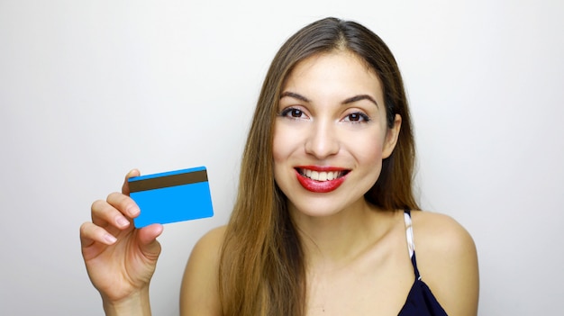 Closeup portrait of happy young woman with showing credit card