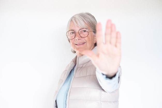 Closeup portrait headshot senior woman looking at camera stop gesture quiet silence