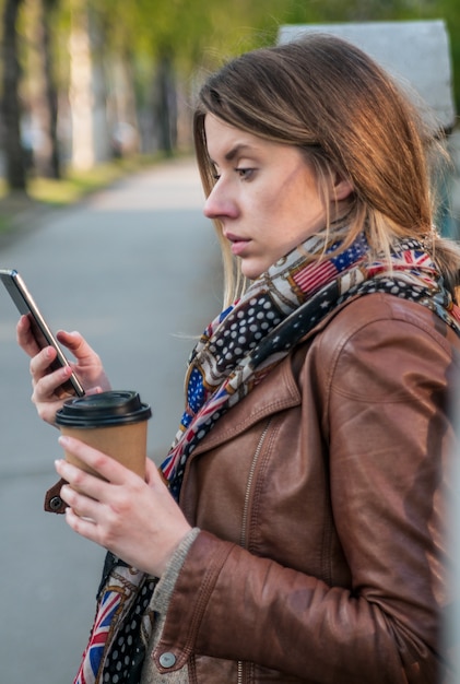 Photo closeup portrait, headshot upset sad, skeptical, unhappy, serious woman talking on cell phone isolated outdoor background. negative human emotions, facial expression, feelings, life reaction. bad news