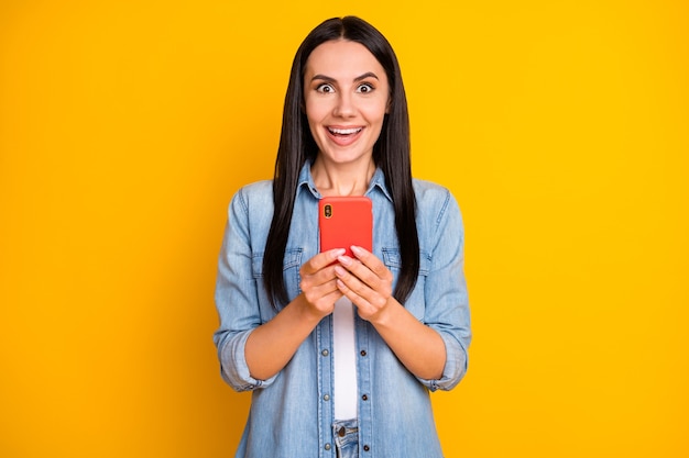 Closeup portrait of lovely cheerful girl using phone browsing web