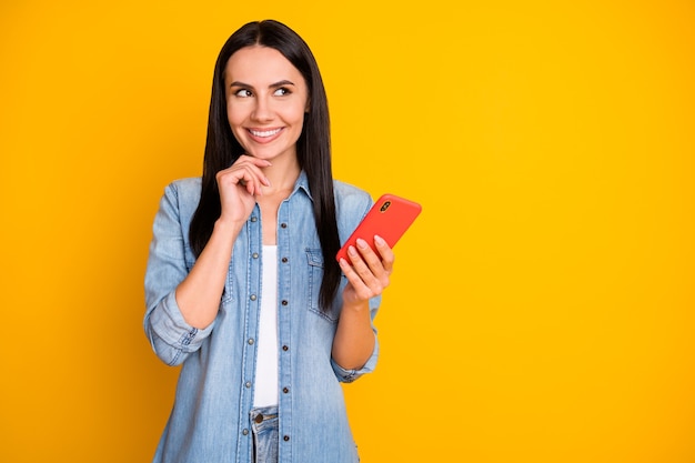 Closeup portrait of lovely cute girl holding in hands device creating new smm post