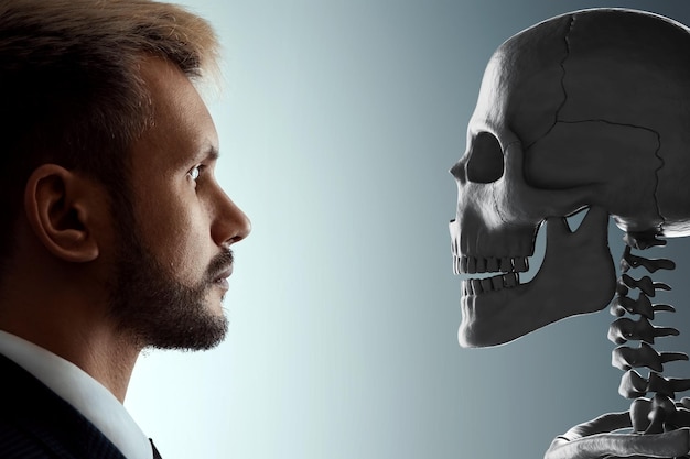 Closeup portrait of a man looking at a human skull facing death Concept of death old age problems aging disease otherworldly Copy space 3D rendering 3D illustration