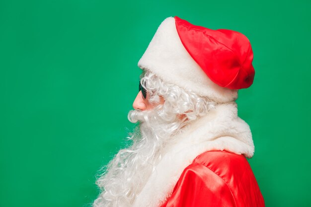 Closeup portrait of man with santa costume and sunglass.