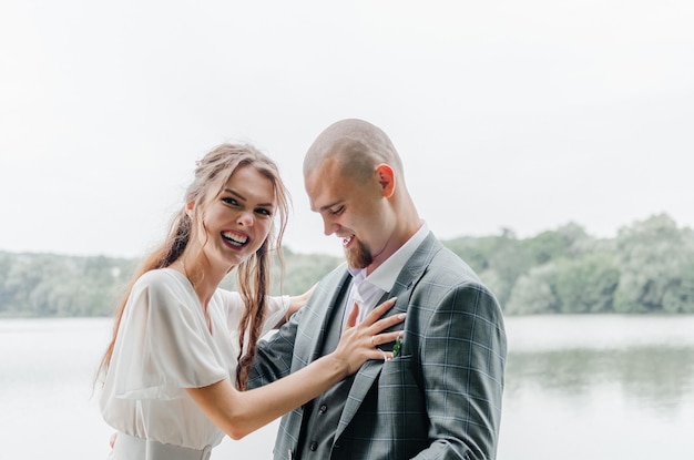 Closeup portrait of the marriage couple brides hug and smile