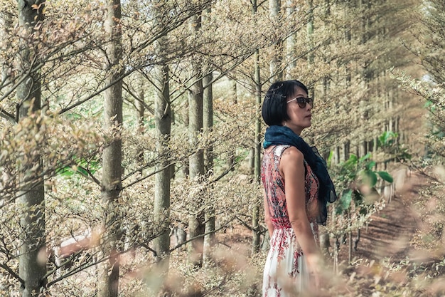 Closeup portrait of modern Asian mature woman at the forest