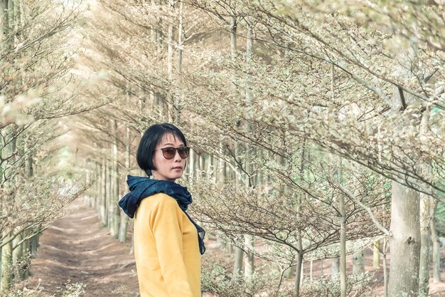 Closeup portrait of modern Asian mature woman at the forest