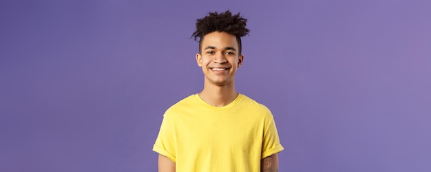 Photo closeup portrait of nice friendlylooking hispanic male student in yellow tshirt grinning delighted l