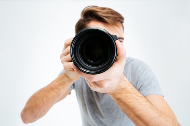 Closeup portrait of photographer making shot on photo camera