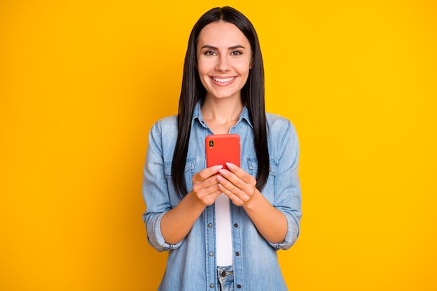 Closeup portrait of pretty cute cheerful girl holding in hands phone