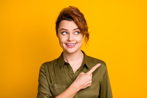 Closeup portrait of pretty glad cheerful girl showing ad copy space