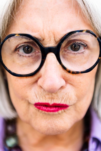 Closeup portrait of senior woman pressing lips