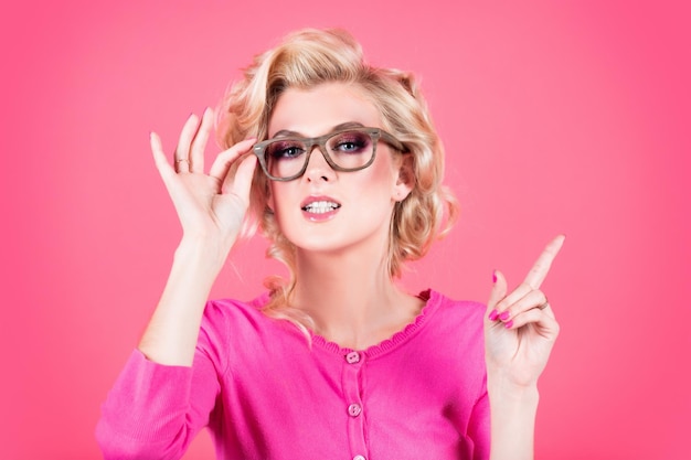 Closeup portrait sexy beautiful blonde woman with glasses isolated on pink background close up portr