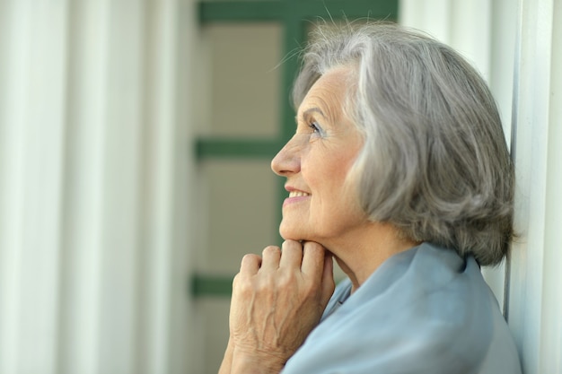 Closeup portrait of smiling dreaming senior woman