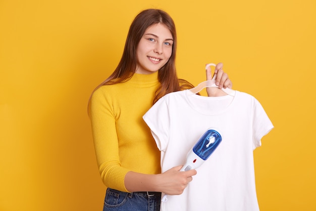 Closeup portrait of smiling lady with hangers in hands