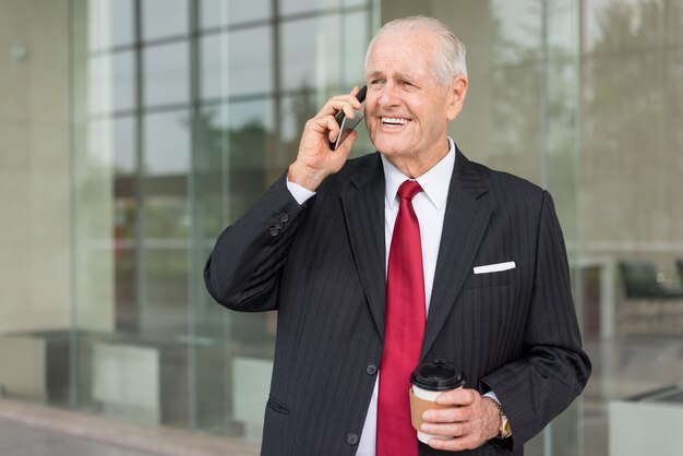 Closeup portrait of smiling senior business man looking at camera