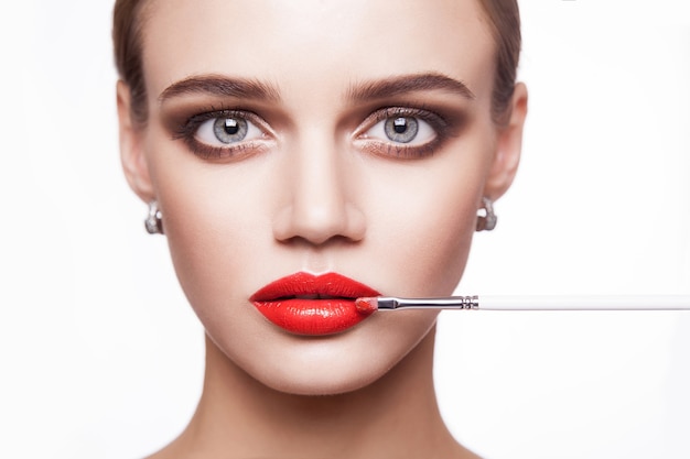 Closeup portrait of woman hand apply makeup on face. beauty and health care concept.