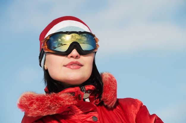 Closeup portrait of a woman in ski glasses looking away