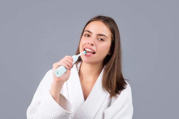 Closeup portrait of womans toothy smile against a gray isolated background with copy space girl brus