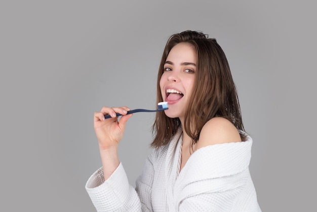 Closeup portrait of womans toothy smile against a isolated background with copy space Girl brushing her teeth Beautiful young woman smile Dental health White tooth