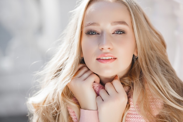 Closeup portrait of young beautiful woman. Female outdoors.